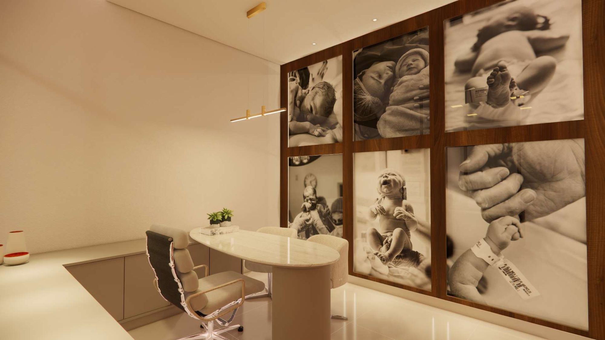 Consultório com mesa de mármore e parede de fotos de nascimentos em preto e branco