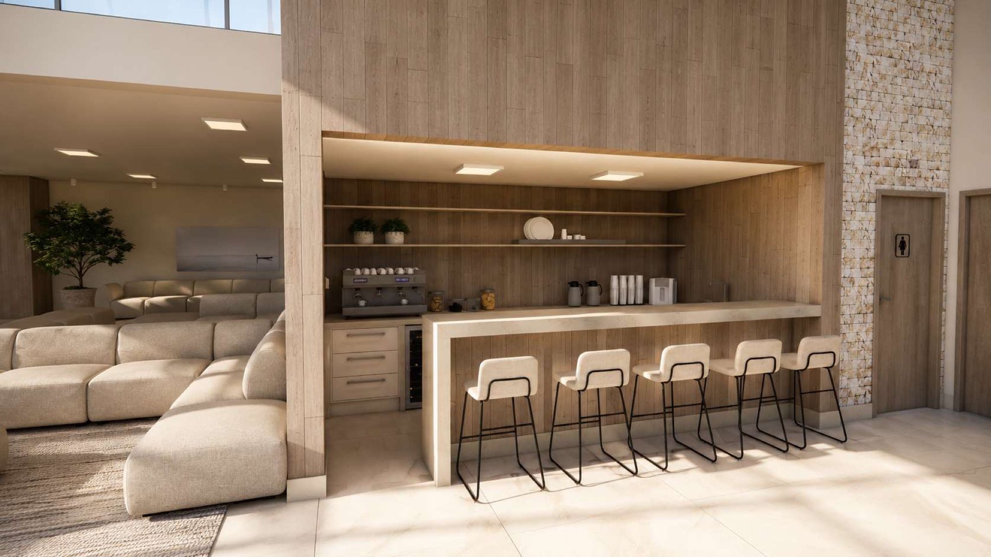 Café da recepção com bancada de pedra e banquetas